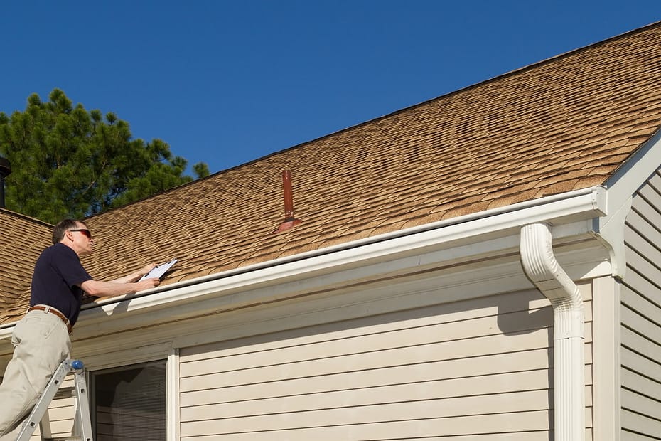A man doing a roof inspection