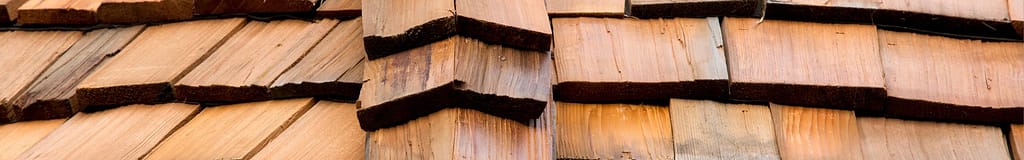 handsawn cedar shingles angled around a roof edge