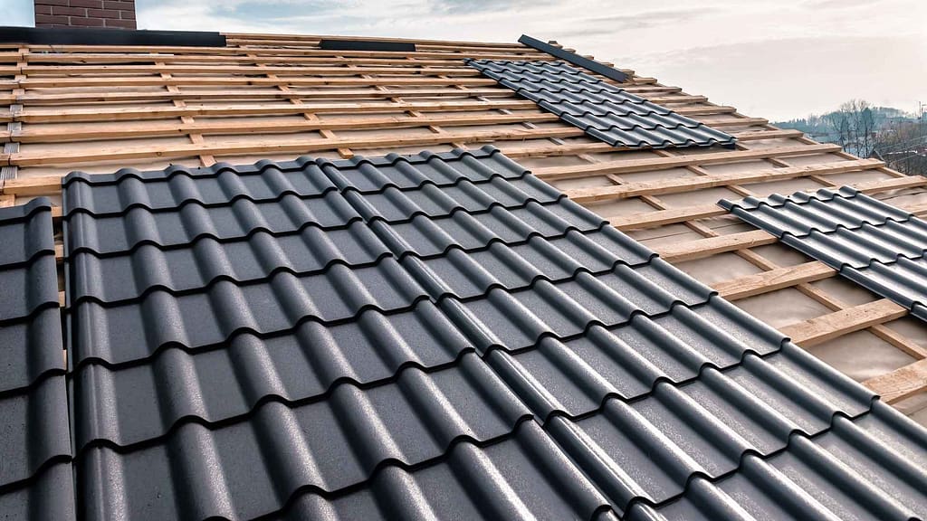 A Barrel style tile roofing being installed on a home.