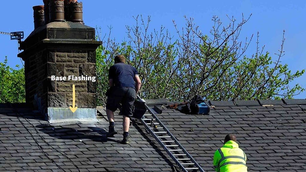 Base Flashing on a roof being repaired by two workers