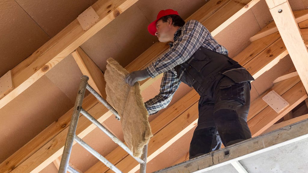 man installing a roof insulation