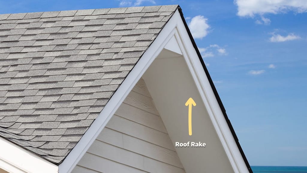 A roof rake on an asphalt shingle roof.