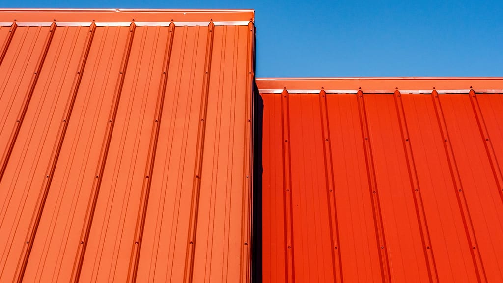 A metal roof in red up close. Metal Roofing is a part of our roof estimate calculator.
