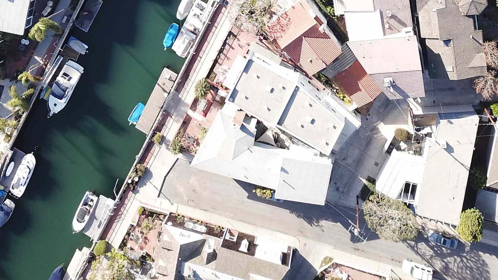 houses scanned by California roofing calculator near body of water with boats