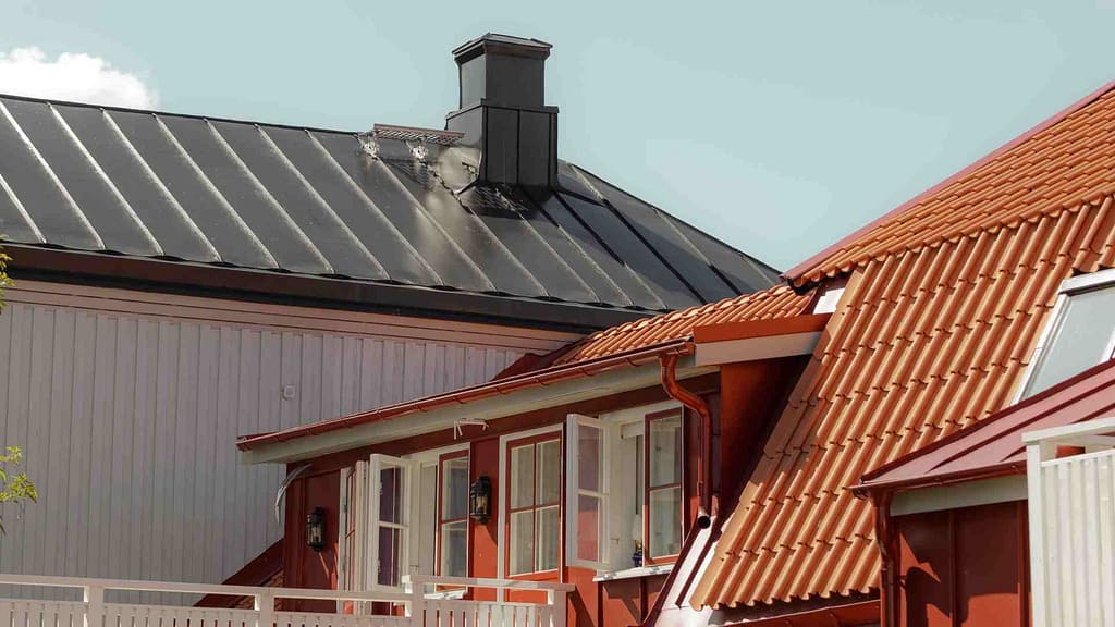 A Metal and Tile roof side by side installed by a Texas roofing contractor