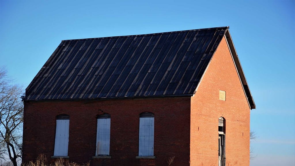 brown house with blue metal roof checked by a skilled Nebraska roofer