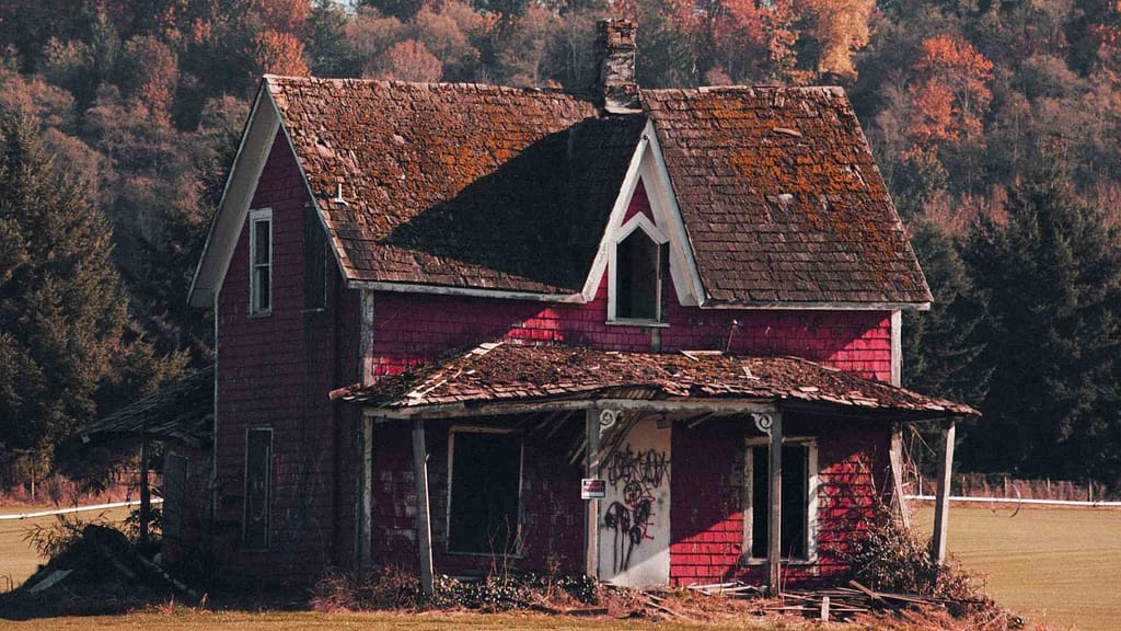 red house and old damaged roof subject to North Dakota new roof cost estimation