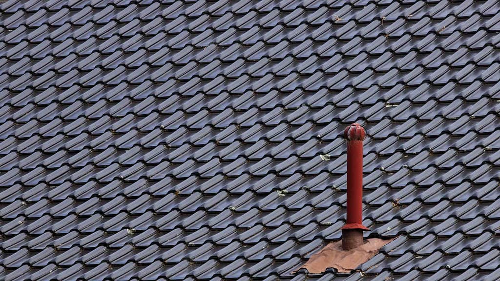 metal gray roofing with chimney rod inspected by Arkansan roofer