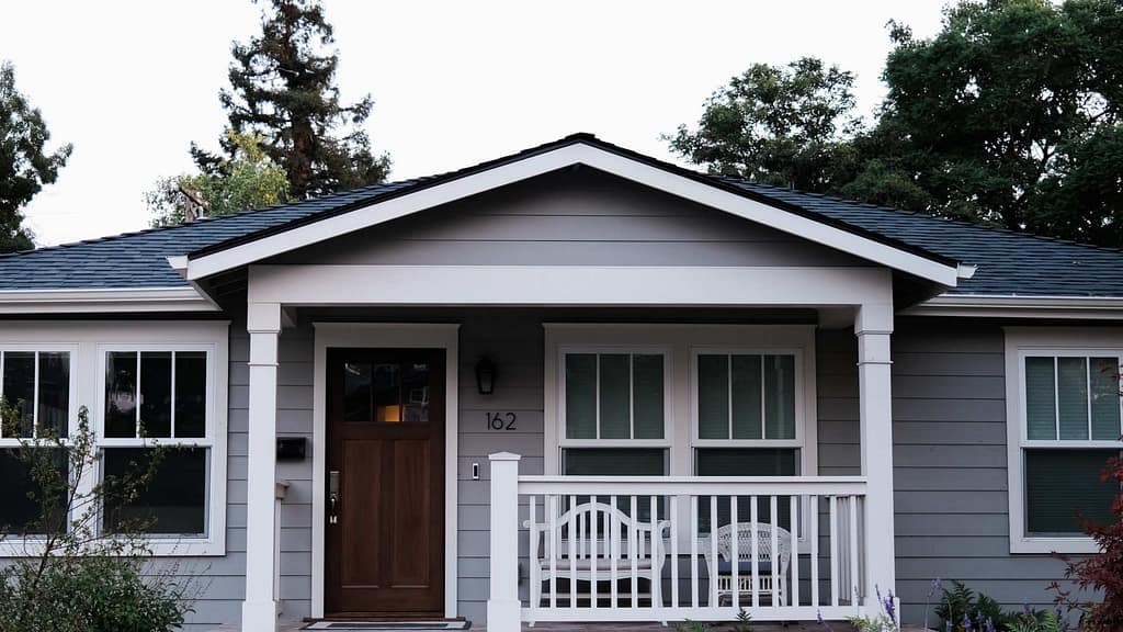 gray white house with dark gray roofing installed by North Carolina roofing contractor