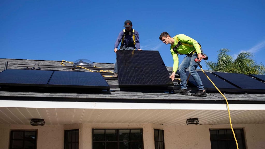 skilled worker from New York roofing contractor installing solar roof panels