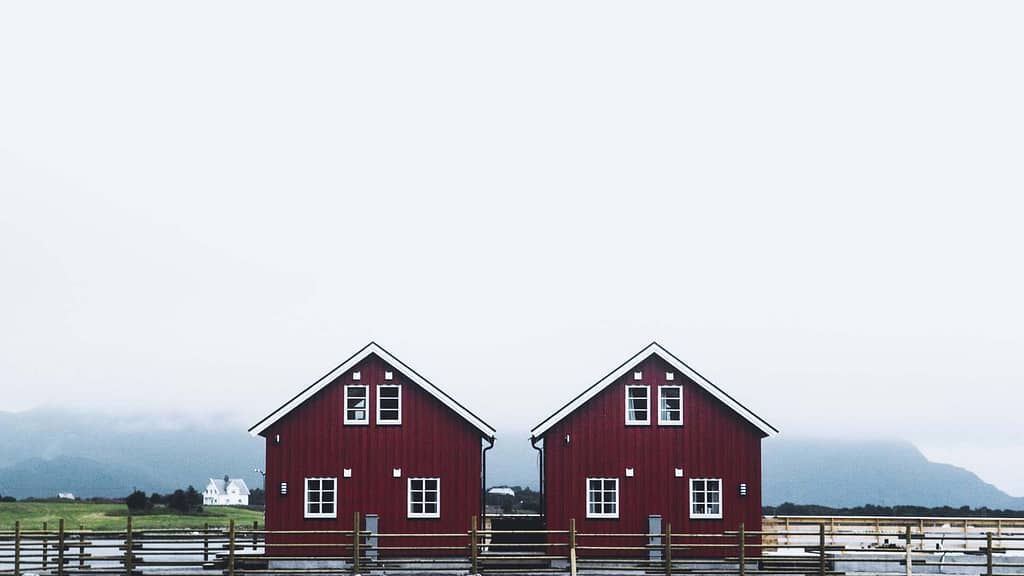 two pitched red home inspected by a skilled Alaska roofer