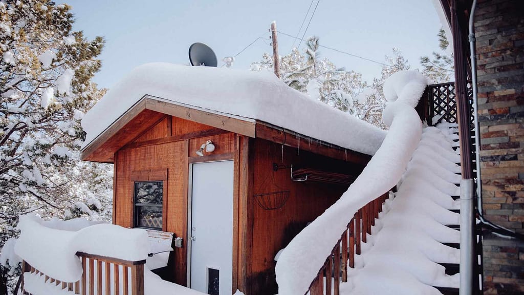 wood home covered in snow