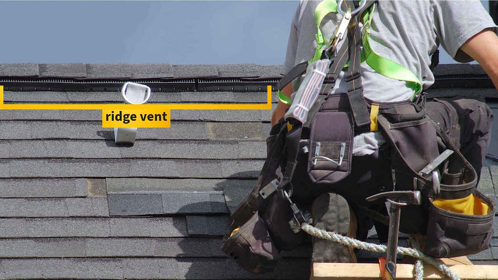 person installing a ridge roof vent