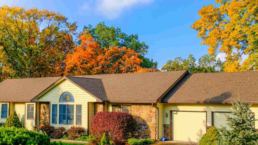 house with brown roof with trees around it