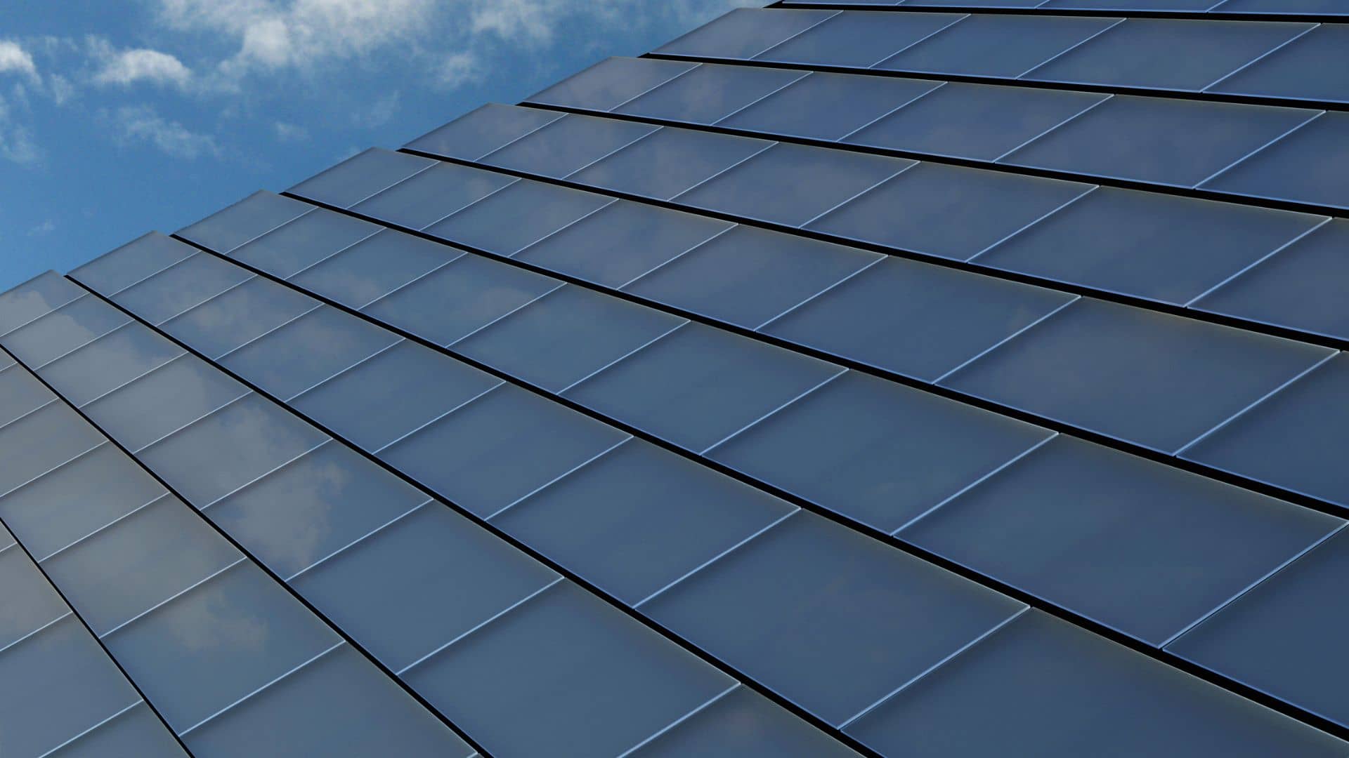 close up of solar tiles on roof against a blue sky