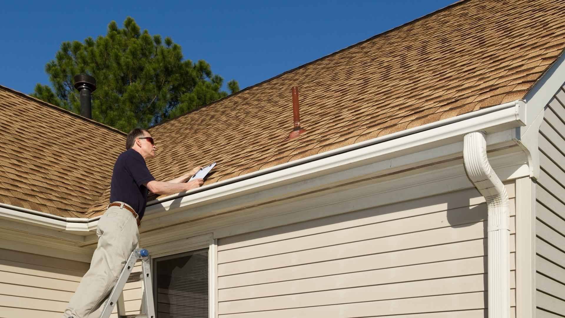 roof inspection happening from a ladder