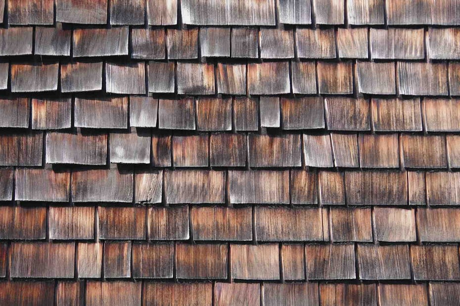 A cedar roof with discoloration and curling shingles.