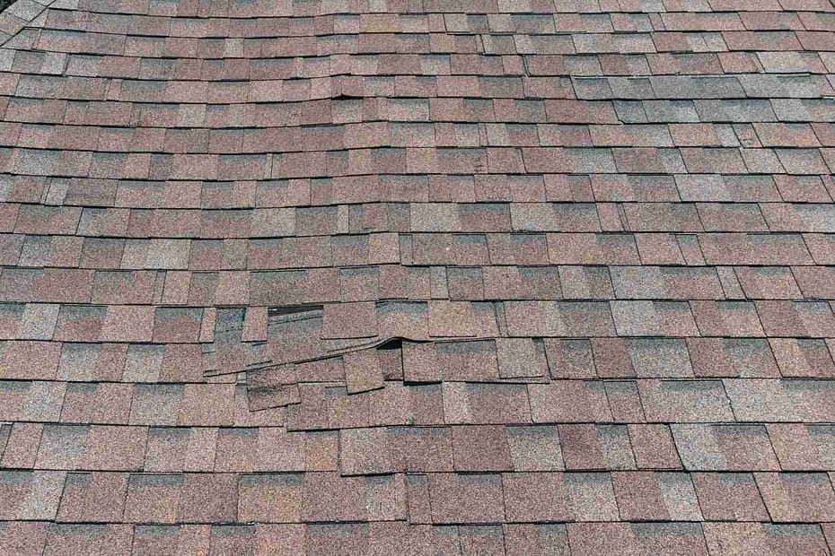 damaged asphalt roof that needs patch