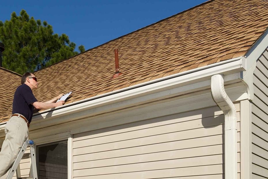 roof inspection happening from a ladder