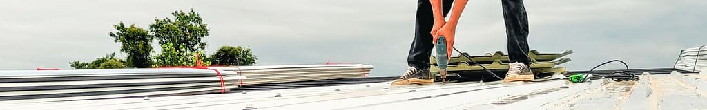 roofer installing a standing seam metal roof