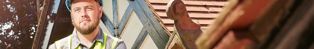 roofer standing in front of detailed historical roof