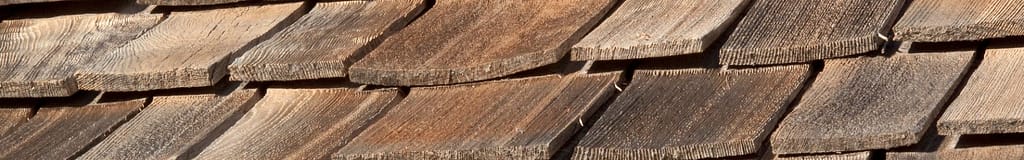 old cedar roof with buckling shingles
