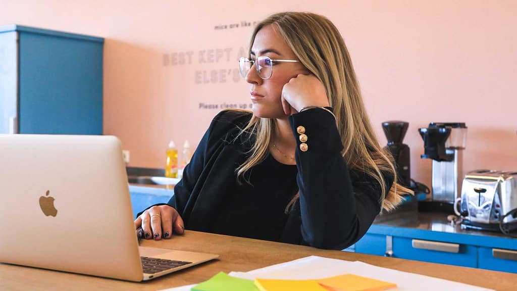 Woman sitting at desk thinking about insurance claim for roof