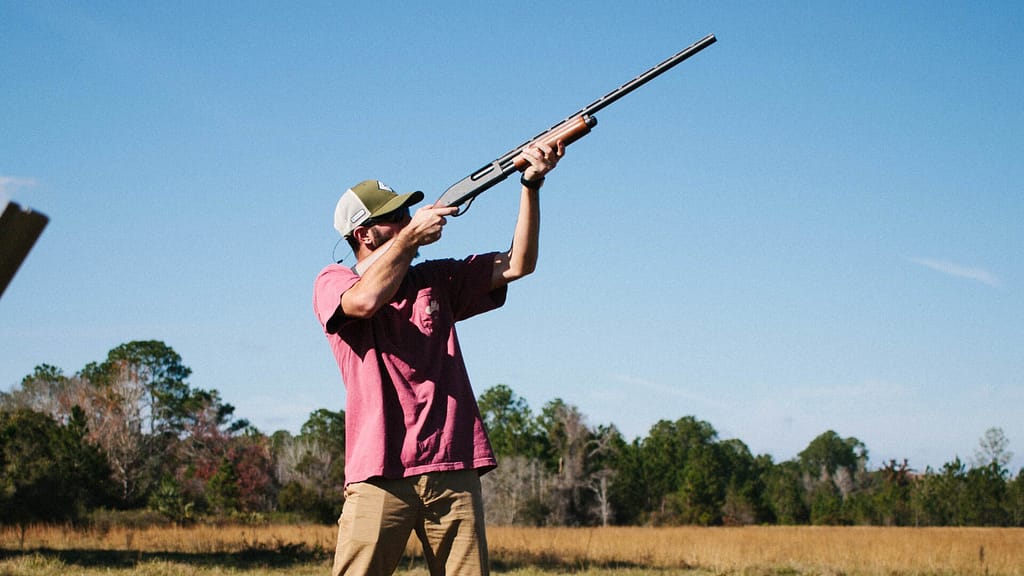 Person shooting a bird in the sky