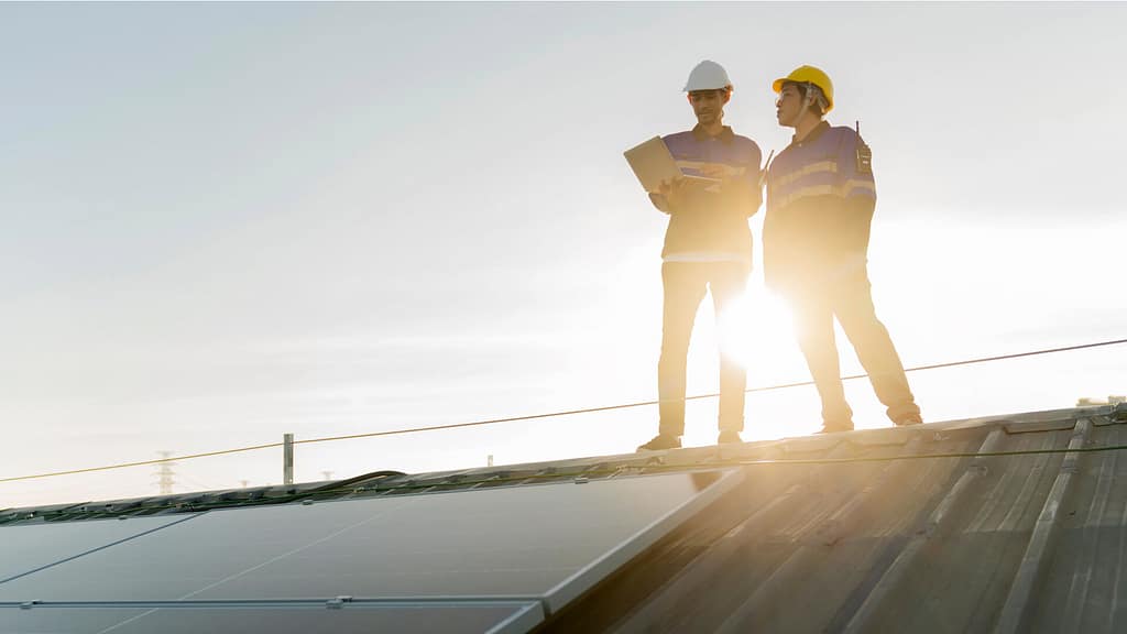 Roofing specialists inspecting roof