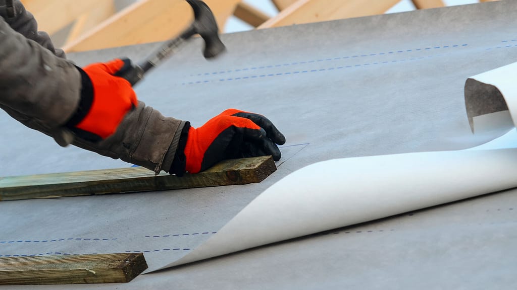 roofer installing a roof underlayment