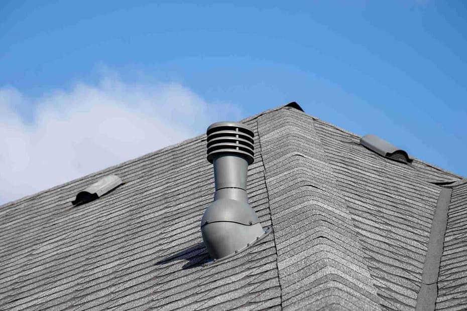 chimney roof vent sitting on an asphalt roof