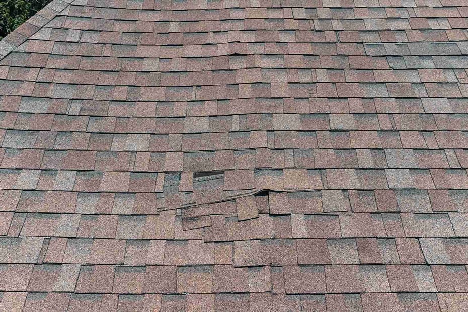 damaged asphalt roof that needs patch