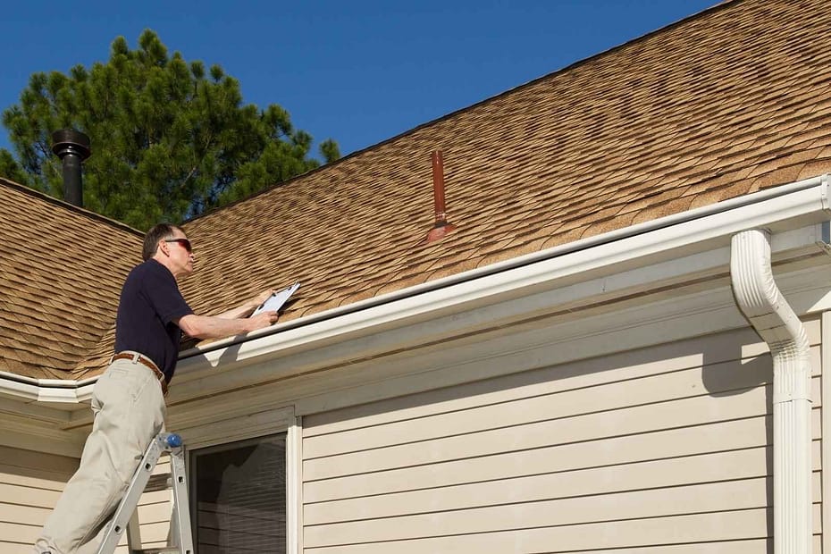 roof inspection happening from a ladder