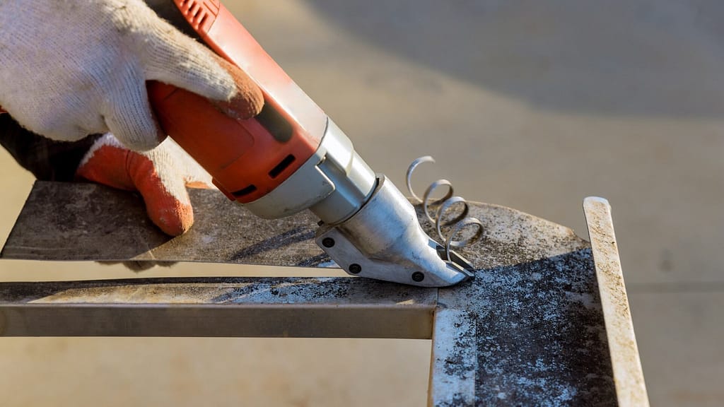 Person using Power Sheets to cut metal