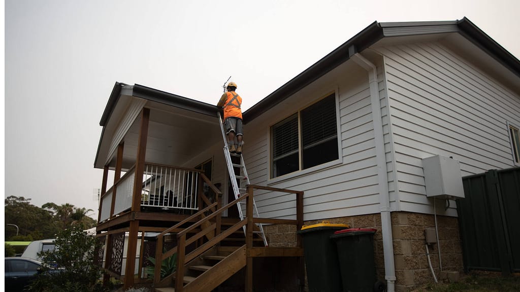 person inspecting roof