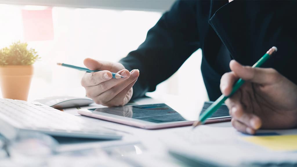 person holding a pencil while planning about financing