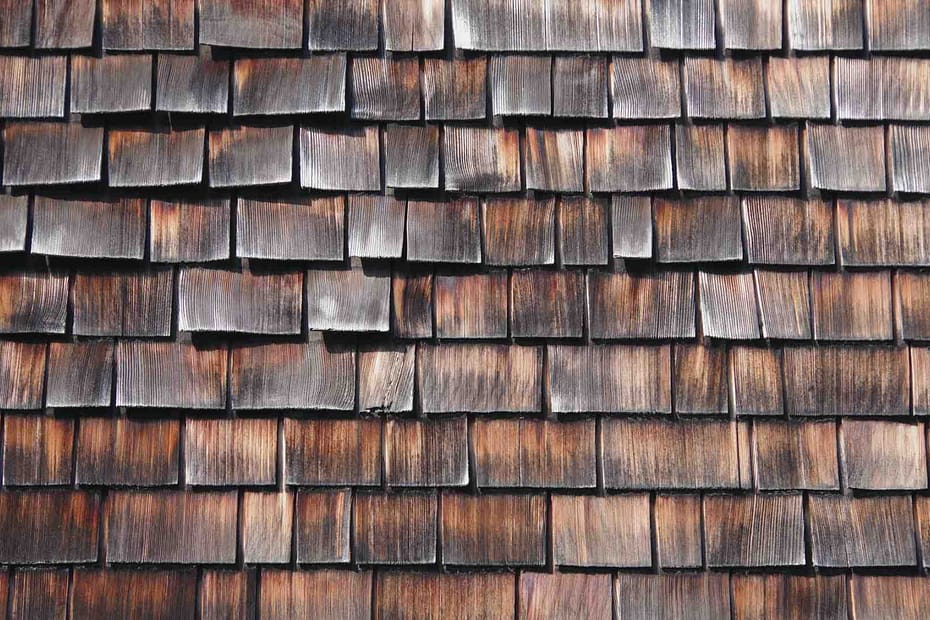 A cedar roof with discoloration and curling shingles.