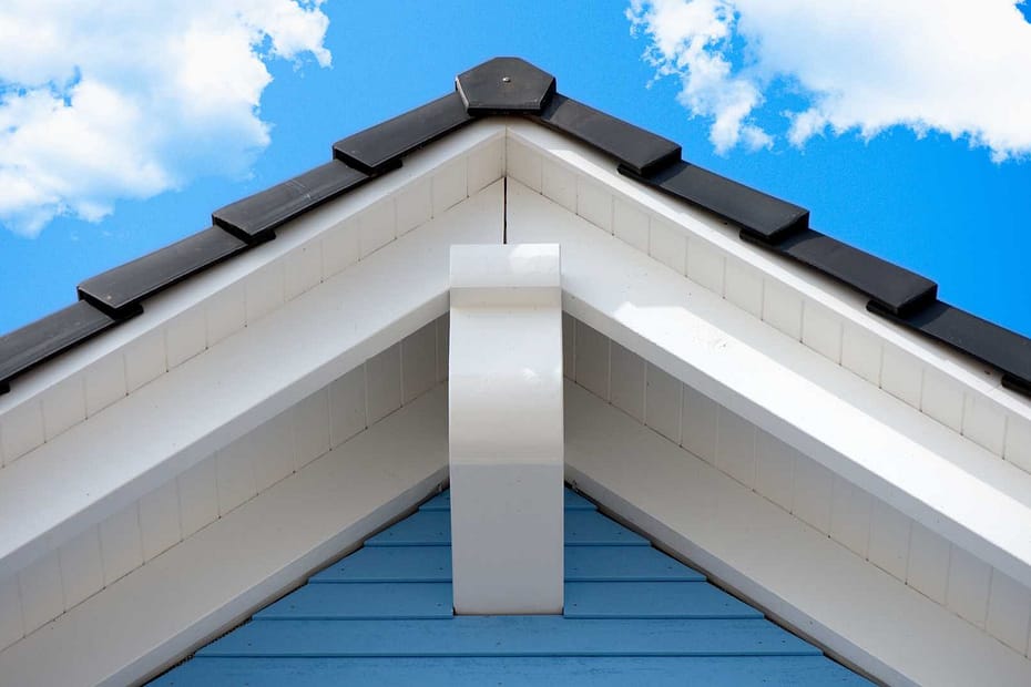 close up of a rake on a roof against a blue sky
