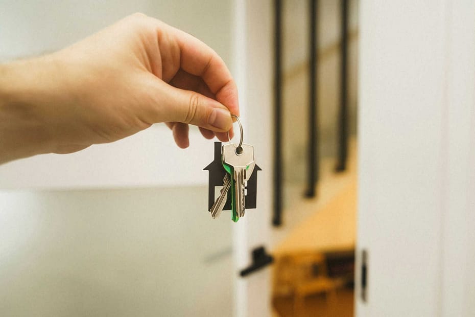 Person holding keys to their new home