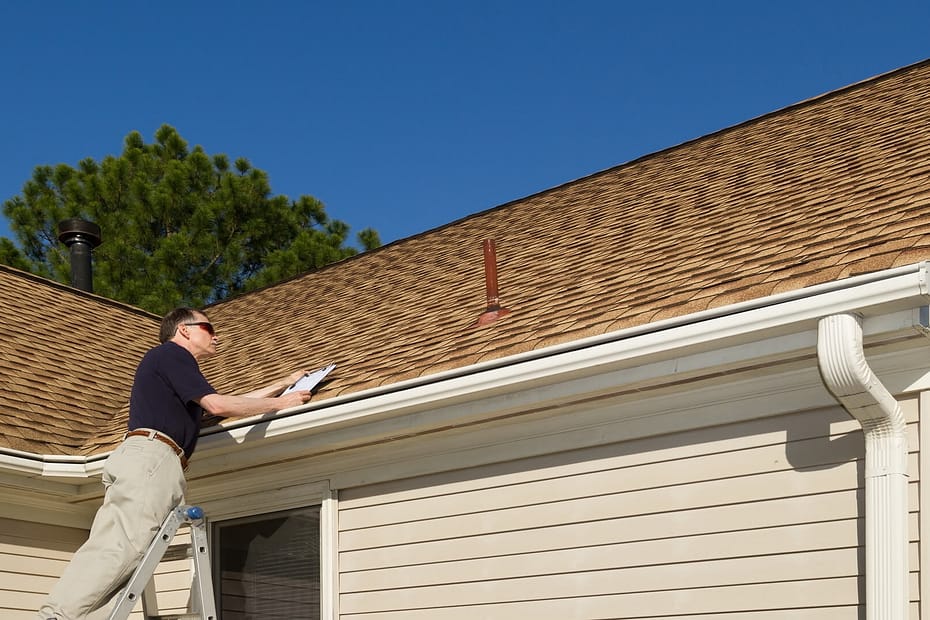 A man doing a roof inspection